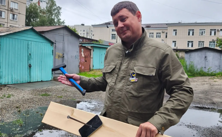 Сеергей Булаев демонстрирует прибитый Айфон
